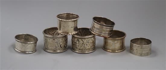 A pair of late Victorian silver napkin rings and five other silver napkin rings.